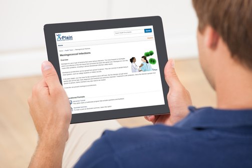 Male looking at X-Plain web based patient education on a tablet